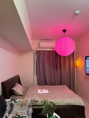 a room with a bed with a pink ceiling at Pocco-breeze-moonlight in Manila