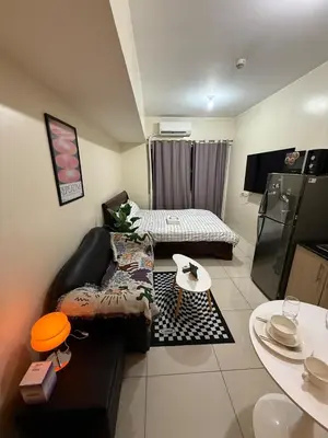 a living room with a couch and a table at Pocco-breeze-moonlight in Manila