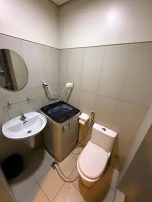 a bathroom with a toilet and a sink at Pocco-breeze-moonlight in Manila