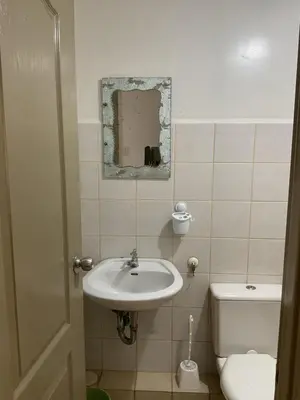 a bathroom with a sink and a toilet at DBK HOMES Sorrento Oasis in Manila