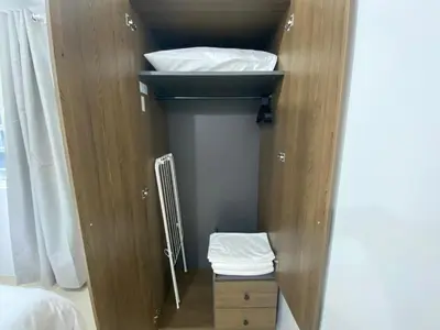 a small closet with a sink and white towels at Near MOA - Cozy Staycation 22D in Manila