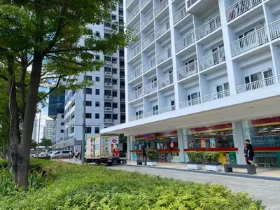 a person walking in front of a building at Near MOA - Cozy Staycation 22D in Manila