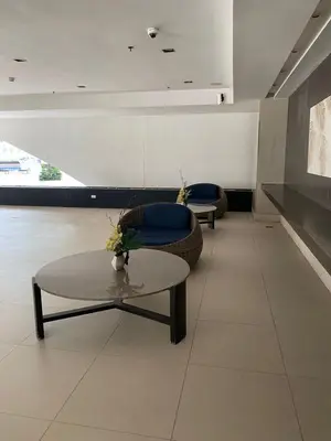 a living room with two chairs and a table at Near MOA - Cozy Staycation 22D in Manila