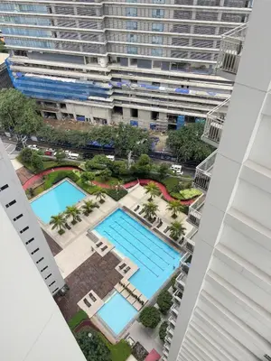 an overhead view of a large building with two pools at Your Urban Oasis in the Heart of Makati in Manila