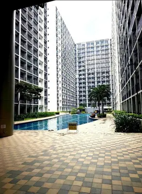a pool in the middle of a city with tall buildings at Pikamon - 15 mins to Airport - Arcade - Shore 2 - MOA in Manila