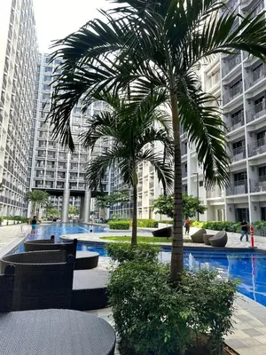 a palm tree in front of a large building at Pikamon - 15 mins to Airport - Arcade - Shore 2 - MOA in Manila