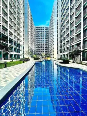 a large swimming pool in a city with tall buildings at Pikamon - 15 mins to Airport - Arcade - Shore 2 - MOA in Manila