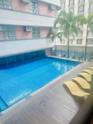 a large swimming pool in front of a building at We Vibe, 101 Newport Blvd near the airport NAIA 3 in Manila