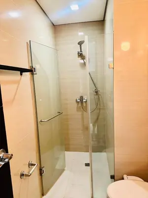 a shower with a glass door in a bathroom at We Vibe, 101 Newport Blvd near the airport NAIA 3 in Manila