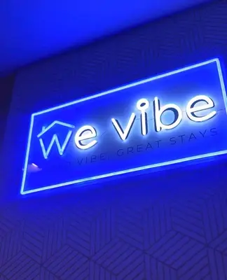a blue sign that reads weeperadi wide openshaw at We Vibe, 101 Newport Blvd near the airport NAIA 3 in Manila