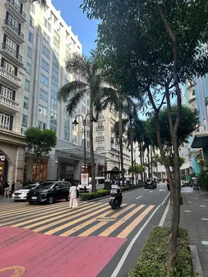 a city street with palm trees and a building at We Vibe, 101 Newport Blvd near the airport NAIA 3 in Manila