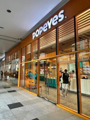 a store front with people standing outside of it at We Vibe, 101 Newport Blvd near the airport NAIA 3 in Manila