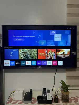 a flat screen tv on a wall with remote controls at Shell residences Tower D in Manila