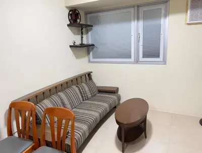 a living room with a couch and a table at Leos room in Manila