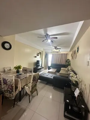 a living room with a table and a couch at Shell Residences -weng's-place in Manila