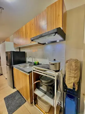 a small kitchen with a stove and a sink at Condotel Near NAIA T1, T2 and CAAP in Manila