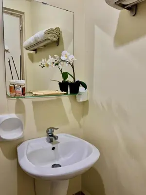 a bathroom with a sink and a mirror at Condotel Near NAIA T1, T2 and CAAP in Manila