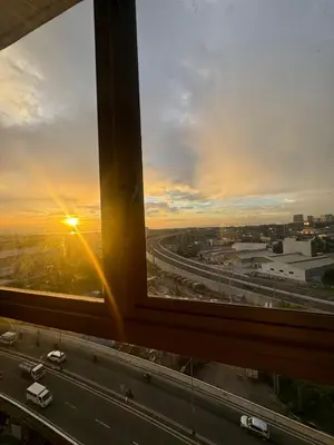 a view from a window of a highway with the sunset at Condotel Near NAIA T1, T2 and CAAP in Manila