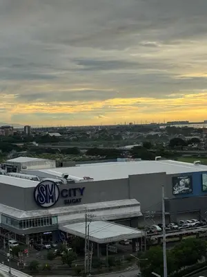 a car dealership with a sign on the side of a building at Condotel Near NAIA T1, T2 and CAAP in Manila