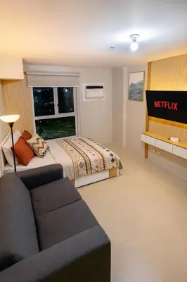a hotel room with a bed and a couch at Condotel Near NAIA T1, T2 and CAAP in Manila