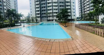 a large swimming pool in a city with tall buildings at New 1BR in Mandaluyong 40SQM in Manila