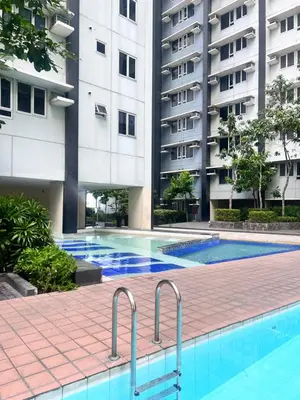 a swimming pool in front of a building at New 1BR in Mandaluyong 40SQM in Manila