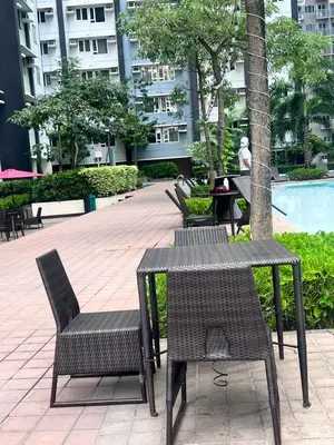 an outdoor table and chairs with a pool in a building at New 1BR in Mandaluyong 40SQM in Manila