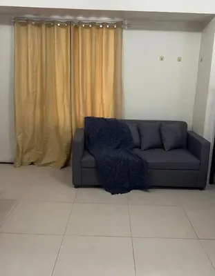a couch sitting in a living room with curtains at New 1BR in Mandaluyong 40SQM in Manila