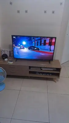 a flat screen tv sitting on a wooden entertainment center at New 1BR in Mandaluyong 40SQM in Manila