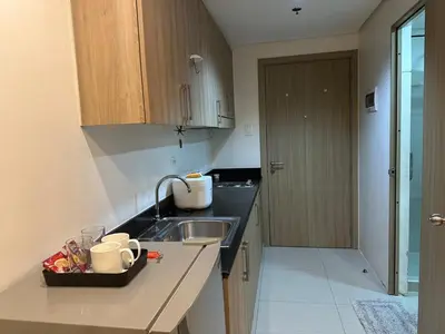 a kitchen with a sink and a counter top at Koro Den at Shore Residences in Manila