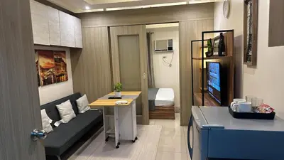 a small living room with a couch and a table at Koro Den at Shore Residences in Manila