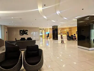 a lobby with couches and chairs in a building at Charm's City Escape at Grace Residences in Manila