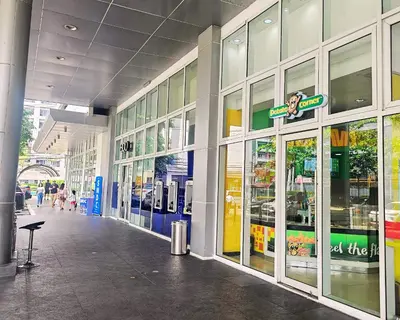 a store front of a shopping mall with glass windows at Charm's City Escape at Grace Residences in Manila