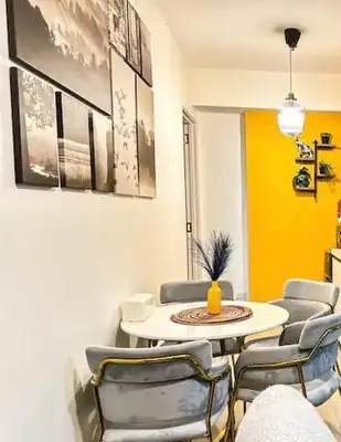 a living room with a table and chairs at Azure Urban Resort Residences Parañaque City in Manila