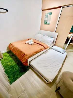 a bed with a stuffed animal on it in a bedroom at Azure Urban Resort Residences Parañaque City in Manila