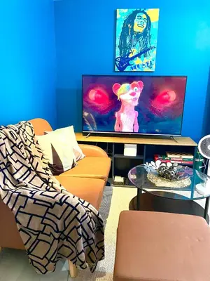 a living room with a couch and a tv at Azure Urban Resort Residences Parañaque City in Manila