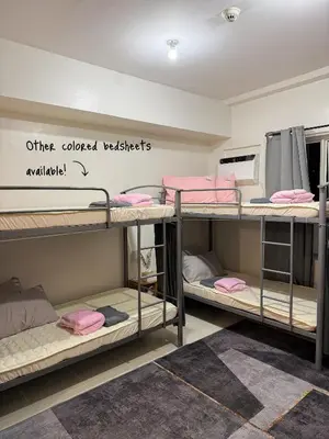 a group of bunk beds in a dorm room at Roomies Spacious Fully Furnished Condo with Balcony and Netflix for 4pax in Manila