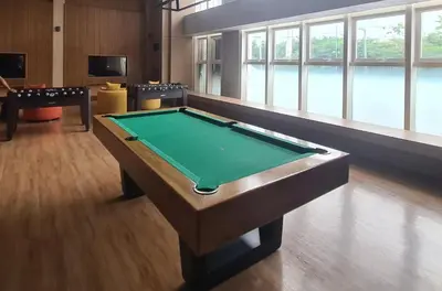 a ping pong table in a room with a pool table at Condo- Park McKinleyWest Big1Br unit -Pool View in Manila