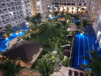 an aerial view of a hotel with a pool and buildings at Shore Residence 2br 5f walking distance MOA near airport in Manila