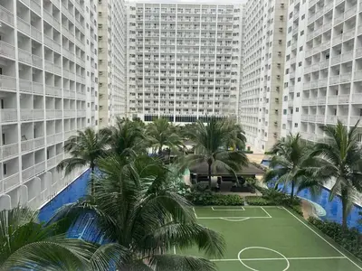 an aerial view of a tennis court in front of tall buildings at SHORE Residence d42 walking distance MOA near Airport in Manila