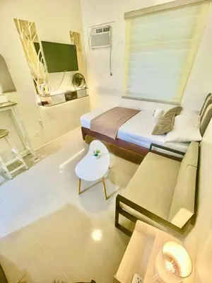a small room with a bed and a couch at Sky Condotel Staycation in Manila