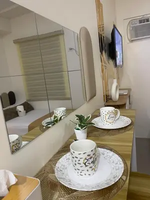 a room with three cups and plates on a table at Sky Condotel Staycation in Manila