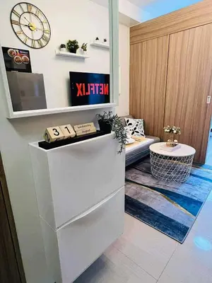 a room with a desk and a clock on the wall at Erin's Place in Manila