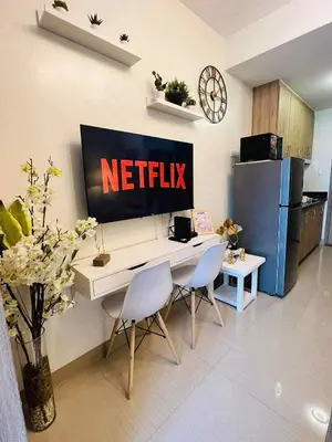 a kitchen with a netflix sign on the wall at Erin's Place in Manila