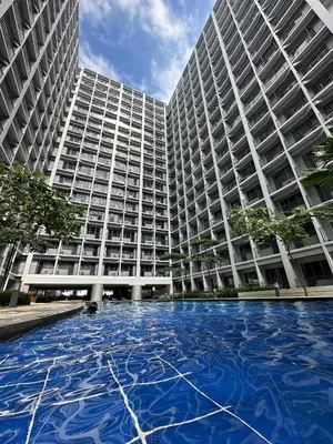 a large building with a large pool in front of it at Erin's Place in Manila