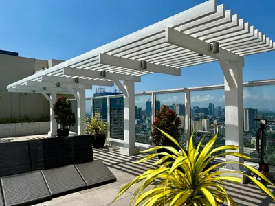 a white pergola on top of a building at Vista Shaw Residences in Manila