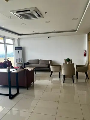 a living room with couches and tables and chairs at Vista Shaw Residences in Manila