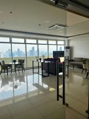 a lobby of an office building with a push sign at Vista Shaw Residences in Manila