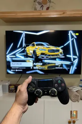 a man holding a video game controller in front of a tv at Pause Point - Standford 3 Suites in Silang