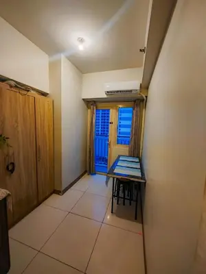 a small room with a table and a window at Levi & Moon's Home in Manila